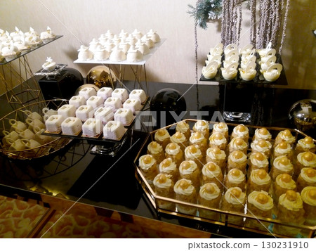 Sweet Table Display Featuring an Array of Festive Desserts at a Corporate Party Celebration 130231910