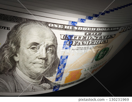 Spot Lit Abstract CLose-up Angle of U.S. 100 Dollar Bills Isolated on a Black Background. 130231969