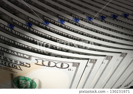 Spot Lit Abstract CLose-up Angle of U.S. 100 Dollar Bills Isolated on a Black Background. Spot Lit Abstract CLose-up Angle of U.S. 100 Dollar Bills Isolated on a Black Background. 130231971