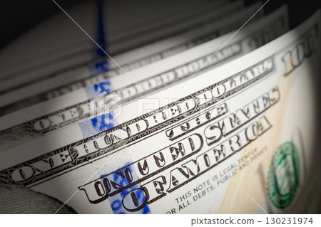 Spot Lit Abstract CLose-up Angle of U.S. 100 Dollar Bills Isolated on a Black Background. 130231974
