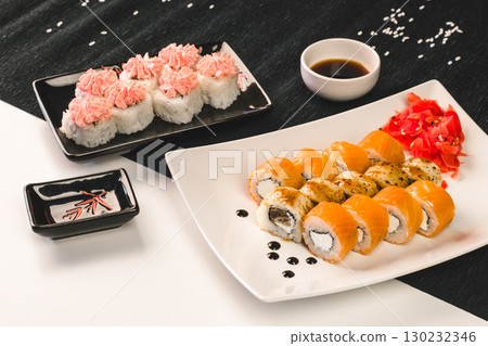 delicious sushi platter with salmon rolls, spicy tuna rolls, and wasabi served. closeup. delicious sushi platter with salmon rolls, spicy tuna rolls, and wasabi served. closeup. 130232346