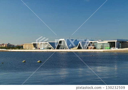 This modern architectural structure is beautifully located neatly by the tranquil waters edge This modern architectural structure is beautifully located neatly by the tranquil waters edge 130232509