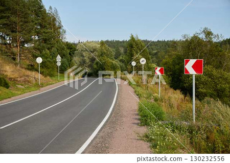 Curvy Roads Surrounded by Beautiful, Lush Greenery in a Picturesque Countryside Landscape Curvy Roads Surrounded by Beautiful, Lush Greenery in a Picturesque Countryside Landscape 130232556