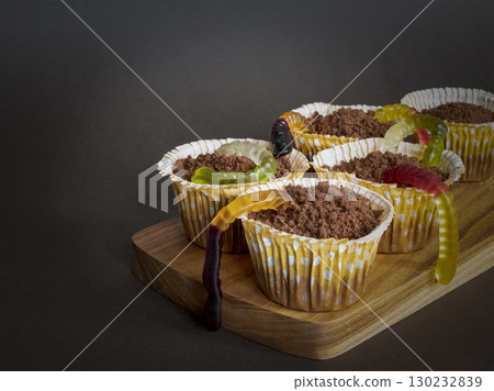 Creepy-cute Halloween cupcakes with gummy worms. Perfect spooky treats for Halloween parties and themed events Creepy-cute Halloween cupcakes with gummy worms. Perfect spooky treats for Halloween parties and themed events 130232839