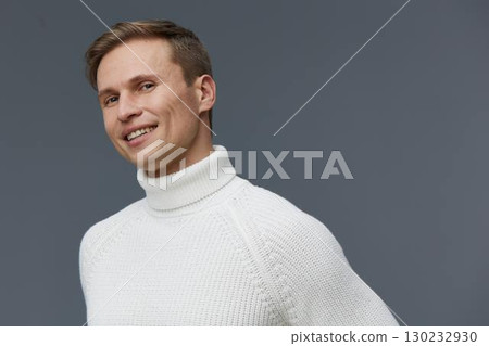 Smiling man wearing white turtleneck sweater look camera portrait isolated grey background concept digital nomad remote work lifestyle 130232930