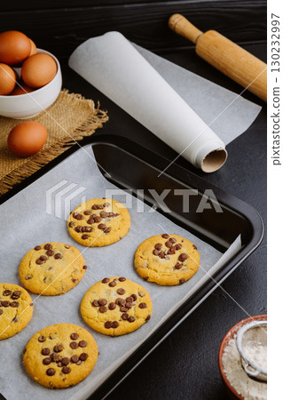 Golden brown chocolate chip cookies cooling on tray, perfect homemade sweet snack Golden brown chocolate chip cookies cooling on tray, perfect homemade sweet snack 130232997