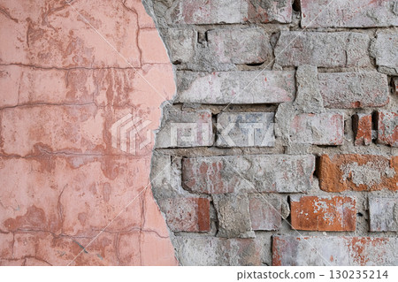 Aged brick wall background with cracked plaster peeling off. Old distressed red brick texture for grunge concept. 130235214