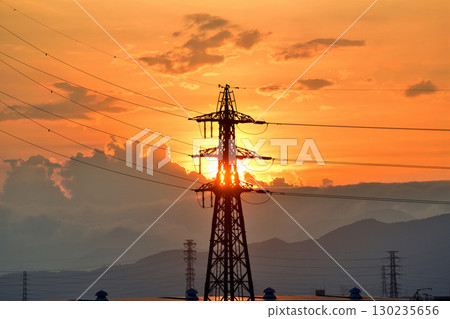 High voltage line tower and sunset High voltage line tower and sunset 130235656