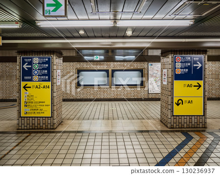 Subway station and exit signs posted in an underground passageway in the city center 130236937