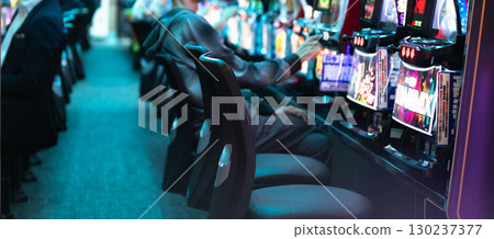 People playing slot machines People playing slot machines 130237377