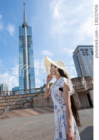 Fukuoka Tower and a young woman in summer Fukuoka Tower and a young woman in summer 130237456