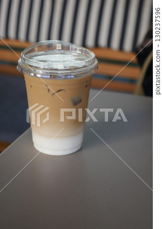 Iced coffee on a table in a cozy cafe setting Iced coffee on a table in a cozy cafe setting 130237596