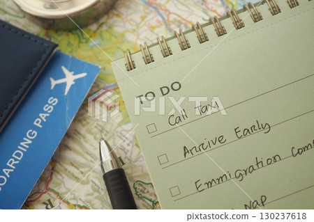 Travel planning checklist with a boarding pass on a map Travel planning checklist with a boarding pass on a map 130237618