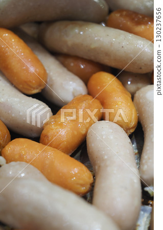 Sausages being cooked in a pan with warm colors and textures Sausages being cooked in a pan with warm colors and textures 130237656
