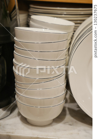 Stacked white bowls in a kitchen display 130237675