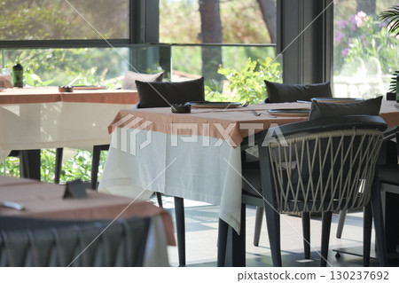 Dining area in a modern restaurant with natural light Dining area in a modern restaurant with natural light 130237692