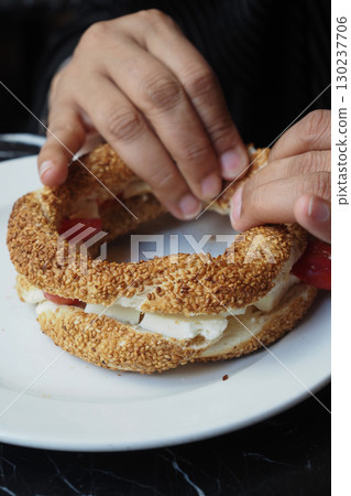 Enjoying a traditional sandwich in a cozy cafe Enjoying a traditional sandwich in a cozy cafe 130237706