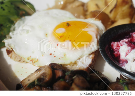 Delicious breakfast with fried egg and vegetables served Delicious breakfast with fried egg and vegetables served 130237785
