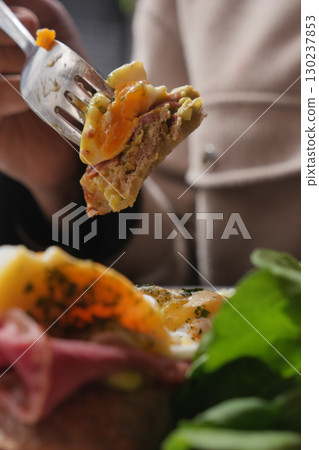 Close-Up of Fork Holding Tasty Food with Fresh Herbs and Greens Close-Up of Fork Holding Tasty Food with Fresh Herbs and Greens 130237853