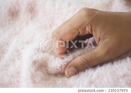 Touching soft pink fabric on a cozy afternoon Touching soft pink fabric on a cozy afternoon 130237935