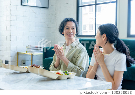 Men and women ordering and eating lunch boxes via delivery 130238038