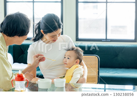 Baby eating baby food 130238056