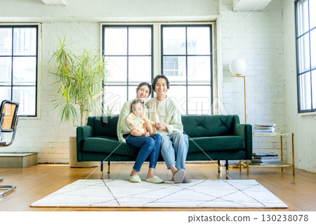 A young couple relaxing in the living room 130238078