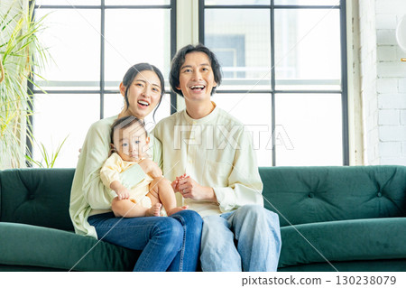 A young couple relaxing in the living room 130238079