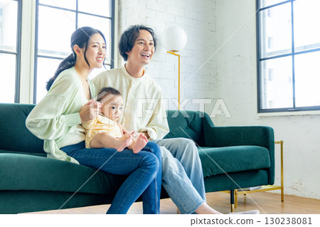 A young couple relaxing in the living room A young couple relaxing in the living room 130238081