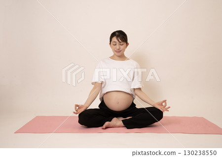 A woman doing maternity yoga A woman doing maternity yoga 130238550