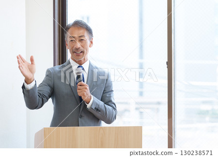 Senior businessman giving a presentation 130238571