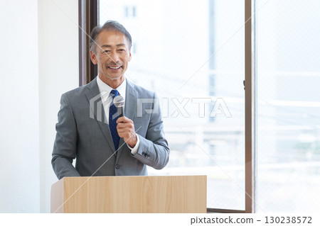 Senior businessman giving a presentation 130238572