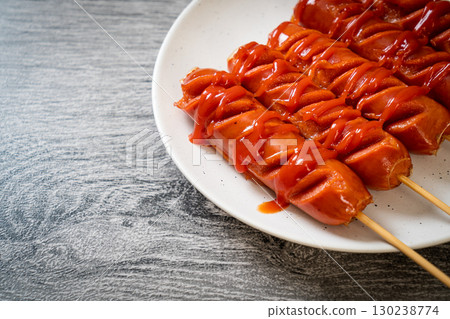 fried sausage skewer with ketchup 130238774