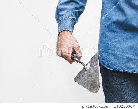 Handsome man, work clothes and masonry trowel Handsome man, work clothes and masonry trowel 130239067