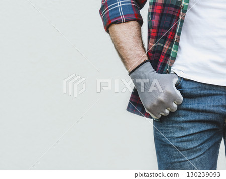 Attractive man, work clothes and protective gloves 130239093