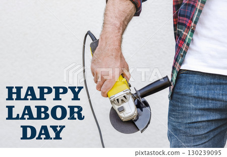 Happy Labor Day. Attractive man and angle grinder 130239095