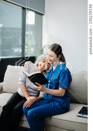 Caregiver doctor examine older patient use blood pressure gauge. woman therapist nurse at nursing home taking care of senior elderly woman sit on sofa. Caregiver doctor examine older patient use blood pressure gauge. woman therapist nurse at nursing home taking care of senior elderly woman sit on sofa. 130239336
