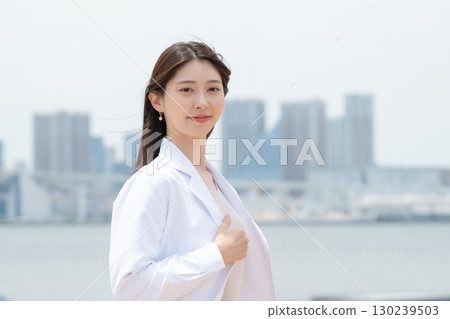 A woman in a white coat A woman in a white coat 130239503