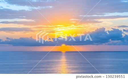 Golden Hour Ocean: Sunburst Through Clouds Over Calm Blue Waters 130239551