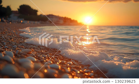 Golden Hour Waves Crashing on Pebble Beach with Distant Coastal 130239625