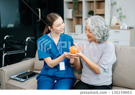 Caregiver doctor examine older patient use blood pressure gauge. woman therapist nurse at nursing home taking care of senior elderly woman sit on sofa. Caregiver doctor examine older patient use blood pressure gauge. woman therapist nurse at nursing home taking care of senior elderly woman sit on sofa. 130239663