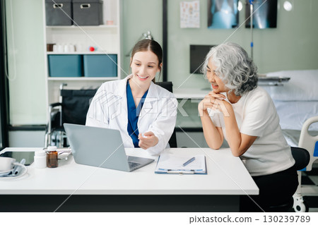 Doctor discussing treatment with male patient talking and laughing sitting on examination bed in clinic or hospital Doctor discussing treatment with male patient talking and laughing sitting on examination bed in clinic or hospital 130239789