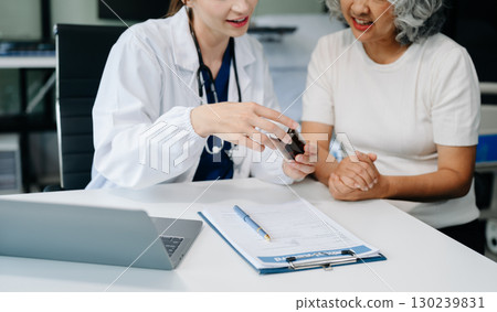 Doctor discussing treatment with male patient talking and laughing sitting on examination bed in clinic or hospital Doctor discussing treatment with male patient talking and laughing sitting on examination bed in clinic or hospital 130239831