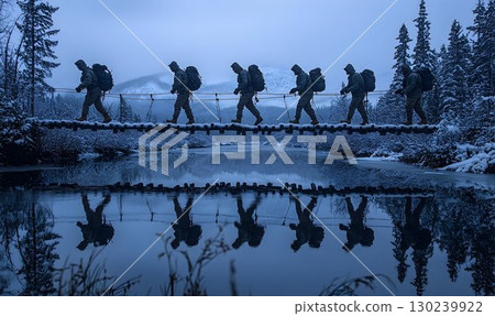 Silhouettes of Hikers on a Snowy Footbridge, Reflected in a Stil 130239922