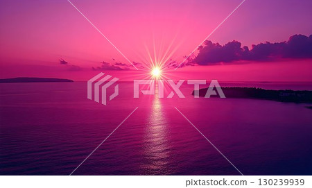 Vibrant Pink Sunset Over Water with Dramatic Light Rays 130239939