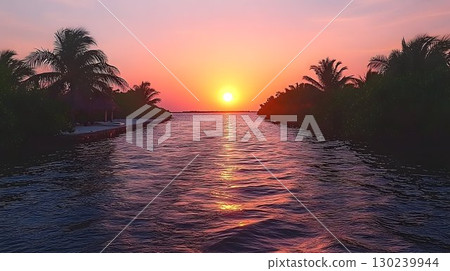 Tropical Sunset Over Calm Waterway Framed by Silhouetted Palm Tr Tropical Sunset Over Calm Waterway Framed by Silhouetted Palm Tr 130239944