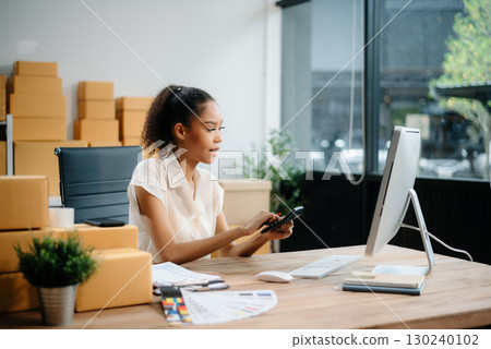 Woman Entrepreneur: SME Business mastering e-commerce with tablet, laptop, packaging, with Online Marketing, Packaging, 130240102