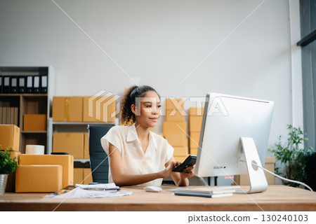 Woman Entrepreneur: SME Business mastering e-commerce with tablet, laptop, packaging, with Online Marketing, Packaging, Woman Entrepreneur: SME Business mastering e-commerce with tablet, laptop, packaging, with Online Marketing, Packaging, 130240103