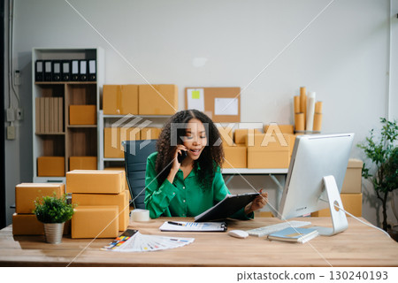 Woman Entrepreneur: SME Business mastering e-commerce with tablet, laptop, packaging, with Online Marketing, Packaging, Woman Entrepreneur: SME Business mastering e-commerce with tablet, laptop, packaging, with Online Marketing, Packaging, 130240193