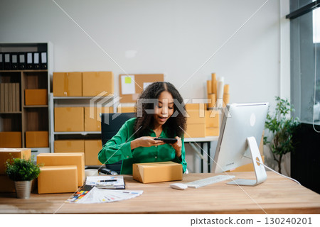 Woman Entrepreneur: SME Business mastering e-commerce with tablet, laptop, packaging, with Online Marketing, Packaging, 130240201